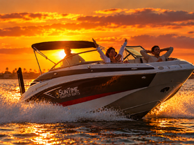 A joyful group enjoys a sunset cruise on a charter boat, capturing the essence of fun and adventure on the water.