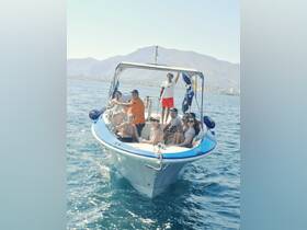 A lively group enjoys a day on the water aboard a boat, capturing the essence of fun and adventure with friends against a stunning backdrop of mountains.