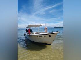 A scenic view of the 'Cap. John Lar' boat docked in calm waters, showcasing its structure against a beautiful sky — perfect for fishing trips or island tours.