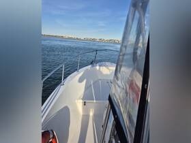 A view of the helm area inside a boat, showcasing the clean and spacious interior, perfect for navigation and relaxation on the water.