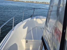A view of the helm area inside a boat, showcasing the clean and spacious interior design, perfect for navigating the waters.
