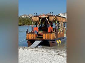 A vibrant tiki boat named 'Tiki Tides' docked on a sandy beach, showcasing its unique design and tropical decor, perfect for fun outings on the water.