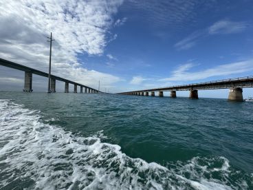 A scenic view of a bridge over water, showcasing the expansive sky and waves, but lacks clarity and focus.
