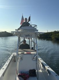 A joyful moment on the water as a child and adult enjoy their time aboard a boat, showcasing the fun of boating adventures.