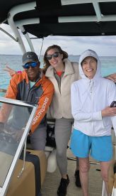 A cheerful group poses together on a boat, showcasing the joy of a day out on the water. Perfect for capturing memorable moments during a boating adventure.