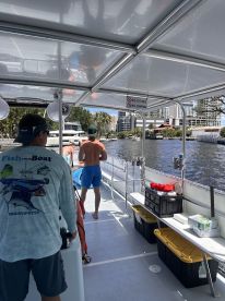 Guests enjoy a sunny day on a boat, with activities underway as they navigate through scenic waterways. Perfect for a fun day out on the water.