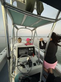 A group of friends enjoys a serene boat ride, taking in the tranquil waters and beautiful surroundings — perfect for a relaxing day on the water.
