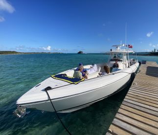 A group enjoys a relaxing moment aboard a boat docked in clear waters, perfect for a day of fun and adventure on the water.