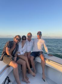 A cheerful group of friends enjoys a moment on a boat, capturing the essence of a perfect day on the water. Ideal for celebrating special occasions or simply enjoying the sun.