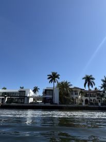 A view of waterfront properties under a clear blue sky, showcasing the serene atmosphere of the area.