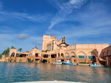 A stunning view of the iconic Atlantis Resort, showcasing its unique architecture against a clear blue sky — a must-see landmark in the Bahamas.