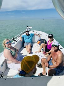 A lively group enjoys a sunny day on a boat, relaxing and having fun together — perfect for memorable outings on the water.
