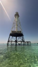A view of a lighthouse structure rising above clear waters, but the image lacks clarity and detail.