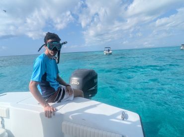 A young boy prepares for snorkeling in the crystal-clear waters, showcasing the excitement of ocean adventures. Perfect for family outings and aquatic exploration.
