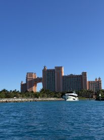 A stunning view of a yacht anchored near the iconic Atlantis resort, showcasing the beautiful turquoise waters and tropical landscape — a perfect destination for luxury boating experiences.