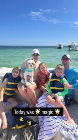 A joyful family enjoys a sunny day on the water with their dog, capturing magical moments aboard their boat. Perfect for family outings and adventures on the sea.