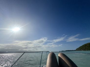 A serene moment on the water, capturing the sun's rays and the calm sea, perfect for relaxation aboard a boat.