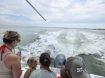 A family enjoys a day on the water, taking in the scenery while cruising on a boat — perfect for creating lasting memories together.