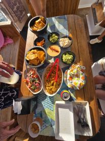 A vibrant spread of snacks and drinks laid out on a boat table, perfect for enjoying a relaxing day on the water with friends.