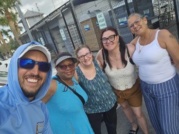 A cheerful group of friends poses for a selfie, capturing their excitement before a boating adventure. Perfect for showcasing fun moments and camaraderie on the water.
