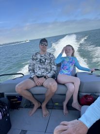 A father and daughter enjoy a day on the water, capturing the essence of family fun aboard a boat. Perfect for creating lasting memories during summer adventures.