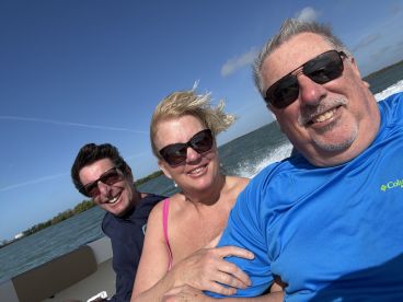 A joyful group enjoys a boat ride, capturing smiles and laughter against a scenic backdrop — perfect for memorable outings on the water.
