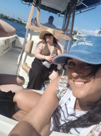 A joyful group enjoys a sunny day on the boat, capturing memories and celebrating together — perfect for fun outings on the water.
