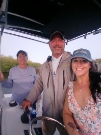A cheerful group of friends poses together on a boat, capturing a memorable moment while enjoying their time on the water.