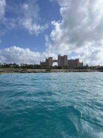 A stunning view of the iconic Atlantis resort in the Bahamas, framed by vibrant turquoise waters and a picturesque sky — perfect for showcasing tropical destinations.