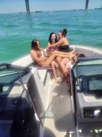 A lively group of friends enjoys a fun day on the water, relaxing and socializing aboard a boat — perfect for summer adventures.