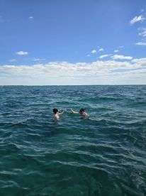Two individuals enjoy a fun snorkeling experience in clear waters, showcasing the joy of aquatic adventures.