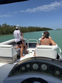 A family enjoys a sunny day on the water aboard a boat, capturing the essence of fun and relaxation during their aquatic adventure.