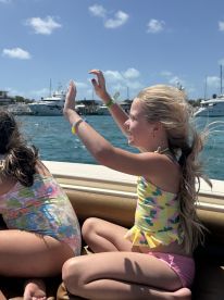 Two children enjoy a joyful moment on a boat, celebrating the fun of a day on the water — perfect for family outings and adventures.