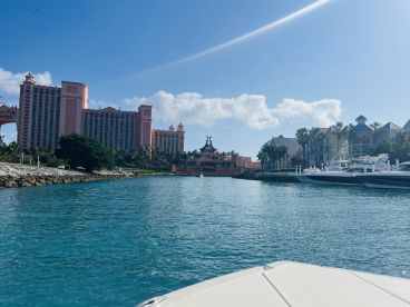 A picturesque view of the Atlantis resort in the Bahamas, showcasing the vibrant architecture and surrounding boats in the harbor — a perfect destination for luxury vacations and boating adventures.