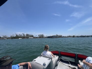 Guests enjoy a scenic boat ride, capturing the beauty of the waterfront and surrounding landscape — a perfect day on the water.