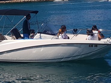 A family enjoys a day on the water aboard a boat, showcasing the joy of group outings and on-water activities.