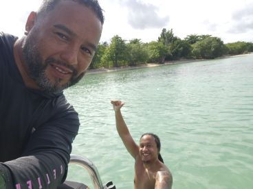 Two friends enjoy a fun moment on the water, celebrating with smiles and excitement — a perfect snapshot of adventure and camaraderie.