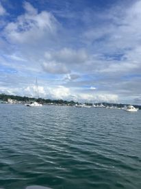 A serene view of a marina filled with various boats under a beautiful sky, perfect for showcasing the charm of waterfront activities.