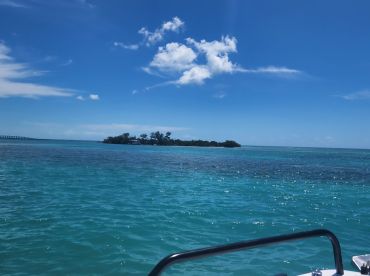 A stunning view of a secluded island surrounded by turquoise waters, perfect for exploring the natural beauty of coastal destinations.