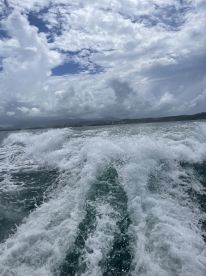A view of turbulent water with clouds overhead, capturing the essence of a boating experience but lacking clarity and focus.