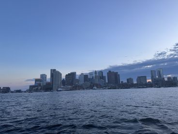 A stunning view of the city skyline at dusk, reflecting on the water — perfect for capturing the essence of urban waterfront experiences.