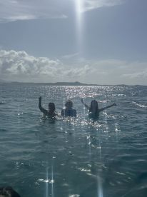 A joyful group of friends celebrates in the sparkling waters, showcasing the fun and excitement of a perfect day on the water.