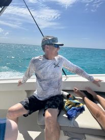A man enjoys a relaxing moment on a boat, surrounded by the beautiful ocean, perfect for a day of leisure on the water.