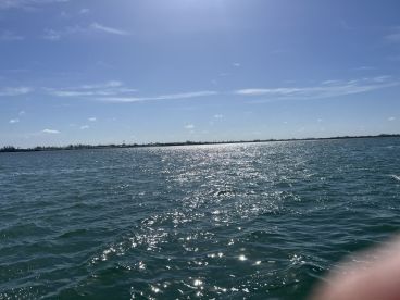A scenic view of shimmering waters under a bright sky, but the image lacks clarity and focus.