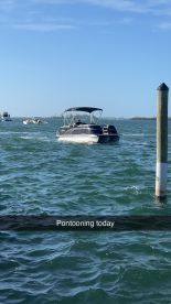 A pontoon boat is seen cruising through the water, perfect for a day of fun on the waves.