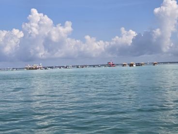 A picturesque view of various boats anchored in clear turquoise waters, showcasing a vibrant coastal scene perfect for water activities and relaxation.