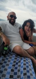 A joyful moment captured on a boat, featuring a man and a child enjoying their time together, perfect for family outings and celebrations on the water.