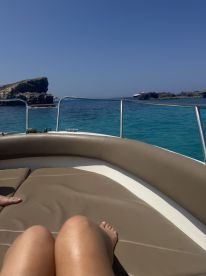 A relaxing moment on a boat with beautiful ocean views, perfect for enjoying the sun and scenery.