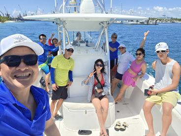 A lively group enjoys a day on the water, capturing fun moments aboard a boat — perfect for celebrations and adventures with friends.