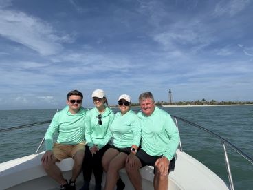 A cheerful group of friends enjoys a day on the water, showcasing the perfect atmosphere for fun and relaxation aboard their boat.
